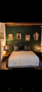 a bedroom with a bed with a green wall at La Terrasse Desaix in Strasbourg
