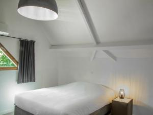 a bedroom with a white bed and a window at Lac Bleu 16 in Lacapelle-Marival +23 photos