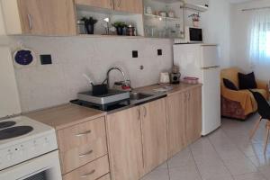 a small kitchen with a sink and a refrigerator at Apartments with parking space Slatine, Ciovo - 16731 in Slatine