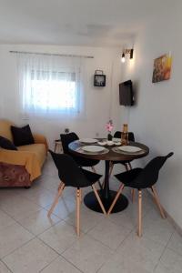 a living room with a table and chairs and a couch at Apartments with parking space Slatine, Ciovo - 16731 in Slatine