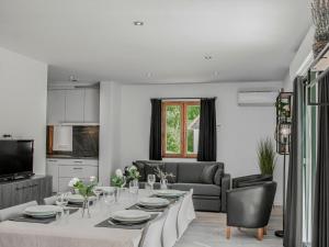 a living room with a dining table and a kitchen at Lac Bleu 16 in Lacapelle-Marival