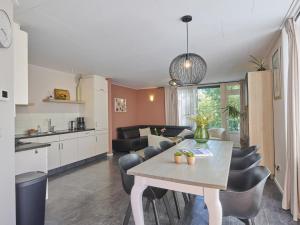a kitchen and living room with a table and chairs at Scheldeoord 54 in Baarland