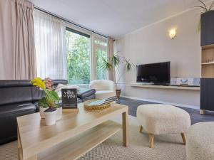 a living room with a couch and a table at Scheldeoord 54 in Baarland