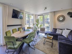 a living room with a table and a couch at L Etage in Kaatsheuvel