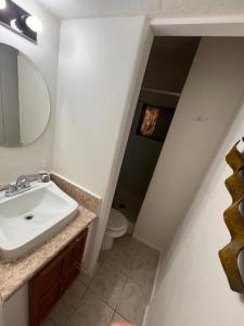 a bathroom with a sink and a toilet at Downtown Purple Apartment in Phoenix