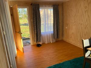 an empty room with a large window and a wooden floor at CasasAnique in Cañete