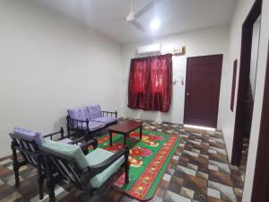 a living room with two chairs and a table at BLISS HomeStay in Sipitang