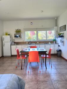 a kitchen with a table and chairs in a room at Loft Las Acacias in Potrero de los Funes