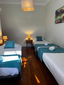 a room with three beds and a table with two lamps at Best House Center - with Garage in Porto