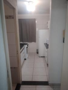 a hallway of a bathroom with a toilet and a sink at Ap Simples arc, bem localizado confortável e aconchegante, 2 quartos in Araçatuba