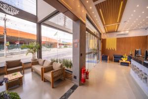 a lobby with couches and tables in a building at Airport Hotel Gru in Guarulhos