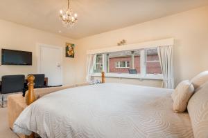 a bedroom with a large bed and a large window at Jones On Wilson Boutique B&B in Burnie