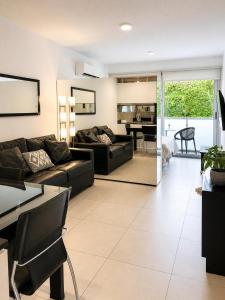 a living room with a couch and a table at Lezama Park ll in Buenos Aires