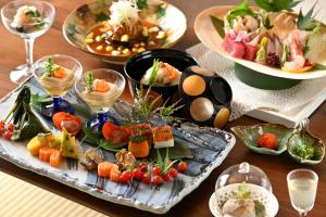 a table with a tray of food and plates of food at Tachibana Shikitei in Kaga