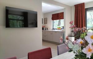 a kitchen with a table with a vase of flowers at 5 Bedroom Luxurious Home In Afferden in Afferden