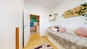 a small room with a bed and a hallway at Vila Golf & Relax, Hrubá Borša in Hrubá Borša