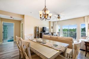 a dining room with a table and a couch at Beachside Resort Condo with Pools and Tennis in Destin