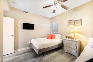a bedroom with a bed and a ceiling fan at Beachside Resort Condo with Pools and Tennis in Destin