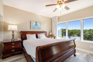 a bedroom with a bed and a ceiling fan at Beachside Resort Condo with Pools and Tennis in Destin +18 photos