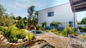 a garden with a swimming pool and a house at Vila Golf & Relax, Hrubá Borša in Hrubá Borša