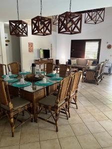 a dining room with a table and chairs and a couch at Casa Brisa do Mar in Pipa