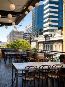 an outdoor patio with tables and chairs and buildings at The Richmond Hotel - Adelaide in Adelaide