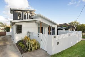 a white fence in front of a house at Lakeshore Serenity @ Warners Bay in Warners Bay