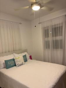 a bedroom with a bed with pillows and a ceiling fan at Las Marías in El Morón