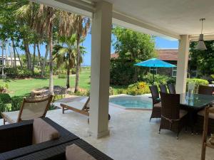 a patio with a table and chairs and a pool at Las Marías in El Morón