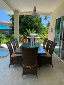 a patio table and chairs with a glass top at Las Marías in El Morón +9 photos