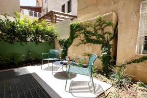 two chairs and a table on a patio at The J Luxury Apartments Near Mahane Yehuda - Perfect for Shabbat Stays in Jerusalem +291 photos