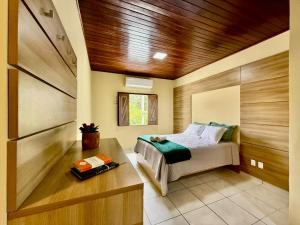 a bedroom with a bed and a wooden ceiling at Refúgio Santarém in Barreirinhas +84 photos
