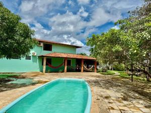a house with a swimming pool in front of it at Refúgio Santarém in Barreirinhas