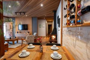 a living room with a table and a fireplace at Casa dos Pinheiros in Resende