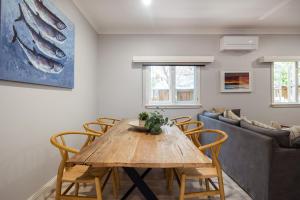 a living room with a wooden table and chairs at Ivy Cottage Milton in Milton