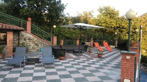 a patio with a table and chairs and an umbrella at Bed&Breakfast Bella Vita in Moneglia