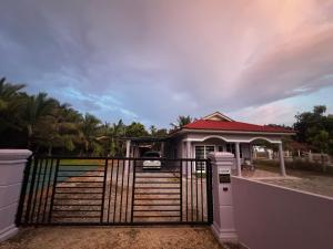a house with a gate in front of it at LOT 1423 Homestay Lonek-Batu Kikir in Bahau