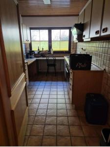 a small kitchen with a table and a chair in it at Nähe Nationalpark in Baiersbronn +18 photos
