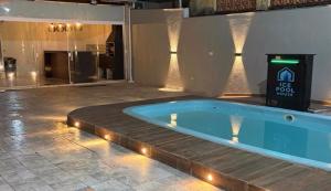 a jacuzzi tub in a lobby with a building at Ice pool house in São Vicente