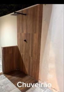 a wooden wall with a small hole in it at Ice pool house in São Vicente