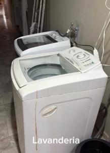 a washing machine with a toilet on top of it at Ice pool house in São Vicente