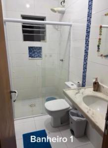 a bathroom with a toilet and a sink at Ice pool house in São Vicente +13 photos