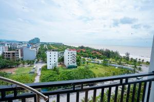 a balcony with a view of the beach and buildings at UFJ HOTEL Sầm Sơn in Sầm Sơn