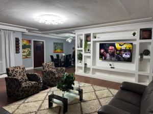 a living room with a flat screen tv on a wall at Raqsea House in Monrovia