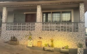 a brick house with potted plants in front of it at Raqsea House in Monrovia