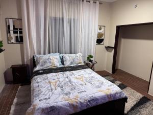 a bedroom with a large bed in front of a window at Raqsea House in Monrovia