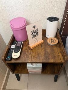 a wooden table with a remote control and a box at Casa privada con estacionamiento in Hermosillo