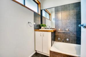 a bathroom with a tub and a sink at The Deck @ VB - Linen, Wi-Fi, Pets, Secured Yard in Venus Bay +30 photos