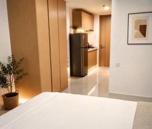 a kitchen with a stainless steel refrigerator in a room at LJ CCC CozyNest at 32 Cebu Fast Wifi Netflix You tube in Cebu City