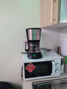 a blender sitting on top of a microwave at Harmony Haven in Rungiri +6 photos